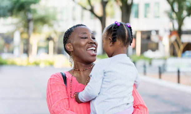 istock Mother holding and looking at her precious daughter 1310111908