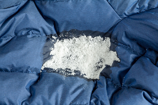Salt on a greasy stain of clothing. Removing oily stains from a down jacket