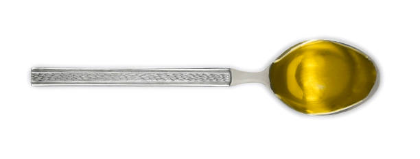 silver spoon of olive oil isolated on white