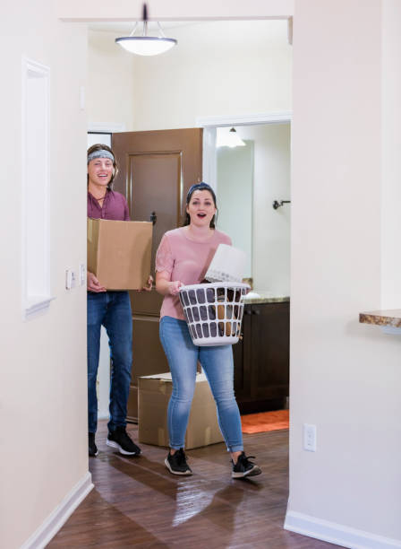 istock Young couple moving into apartment, walk in front door 1310113709