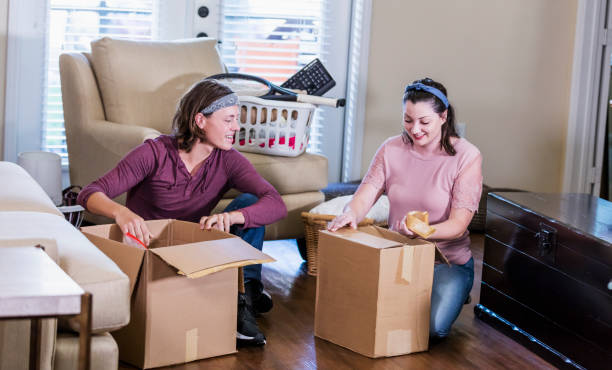 istock Young couple moving into new home, unpacking boxes 1310113795