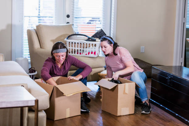 istock Young couple moving into new home, unpacking boxes 1310114358