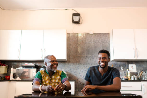 istock African father and son laughing together in kitchen 1310114509