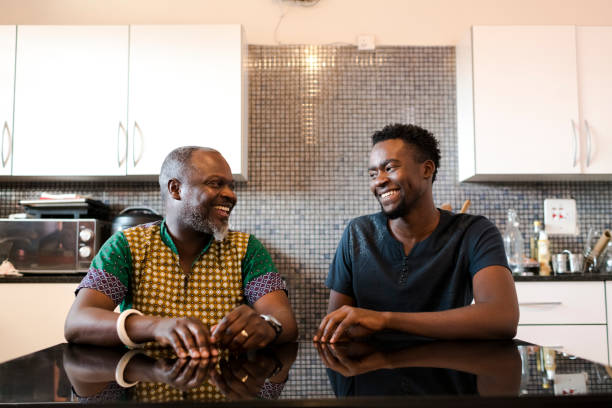 istock Father and son smiling together at kitchen table 1310114552
