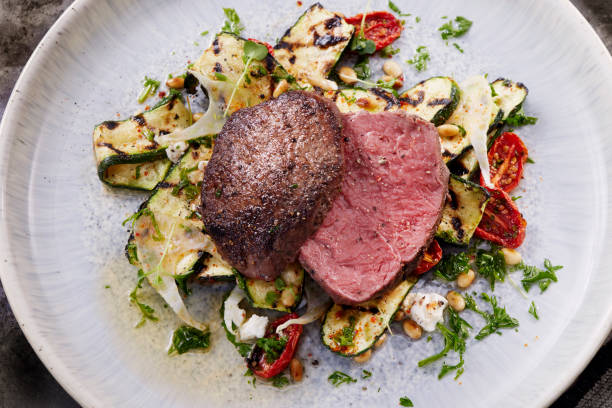 istock Seared Medium Rare Fillet Steak with a Grilled Zucchini Salad 1310114778
