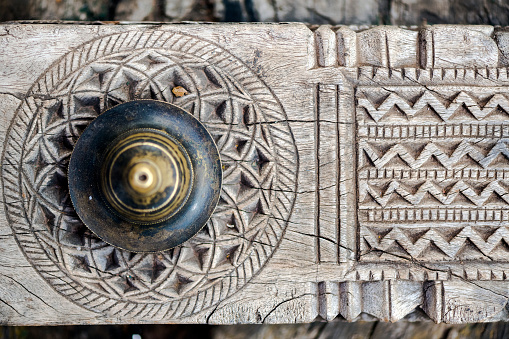 Close-up detailed wood carvings with brass stud on old door