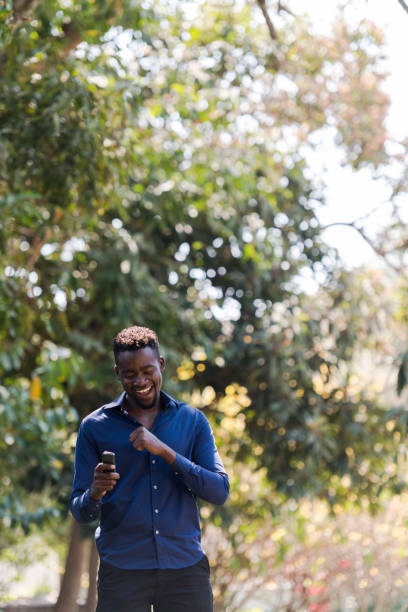 istock Young man laughing at something on his phone 1310114916