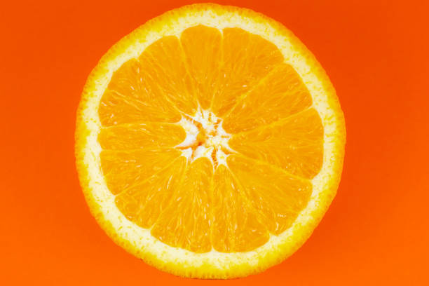 istock Orange fruit on orange background. Minimalism, original beautiful photo. 1310115931