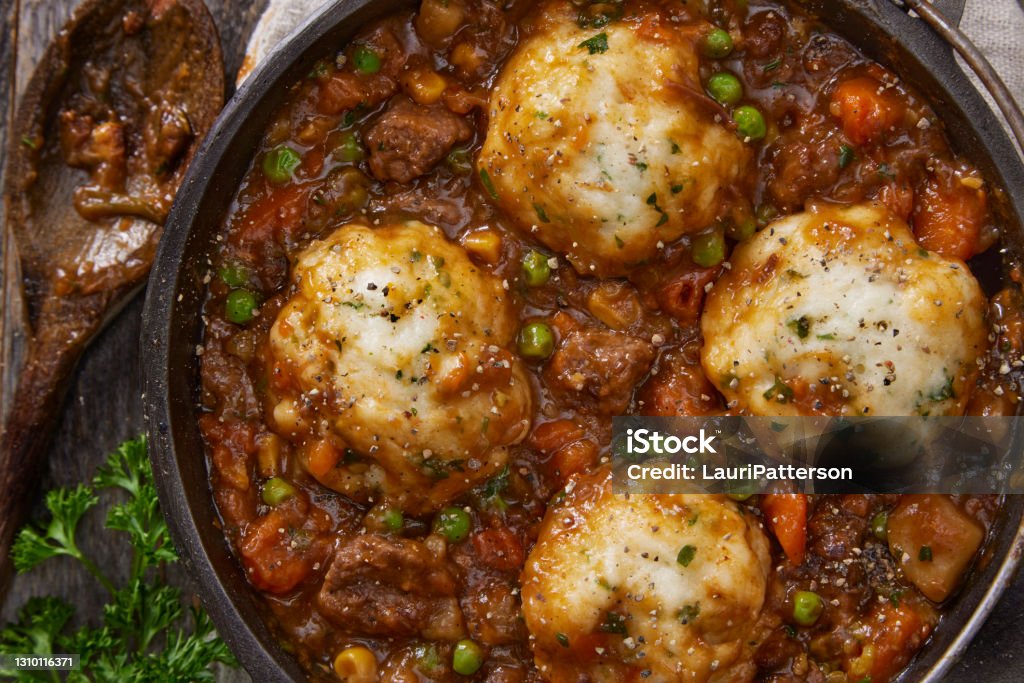 Beef Stew and Dumplings Beef Stew and Dumplings with Potatoes, Green Peas, Celery, Onions and Carrots Dumpling Stock Photo