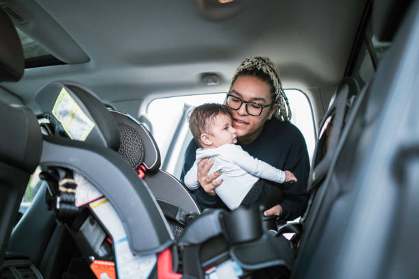 istock Mother Putting Infant Son in Car Seat 1310117467