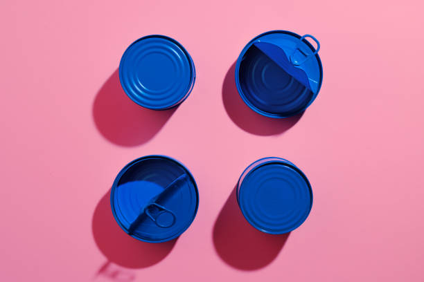 istock Aesthetic concept with blue painted tin can on pink background 1310119768