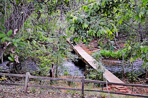 This wood bridge crosses over Oak Creek in Red Rock State Park Sedona Arizona allowing those walking the trail more opportunities for more relaxing views and on this May day the walking trail, the creek all made this a pleasant trail.