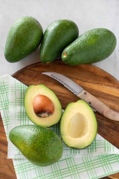 istock Close up of split Avocado on cutting board on marble table 1310120696