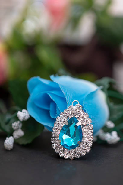 istock a blue diamond brooch in front of blue flower 1310120964