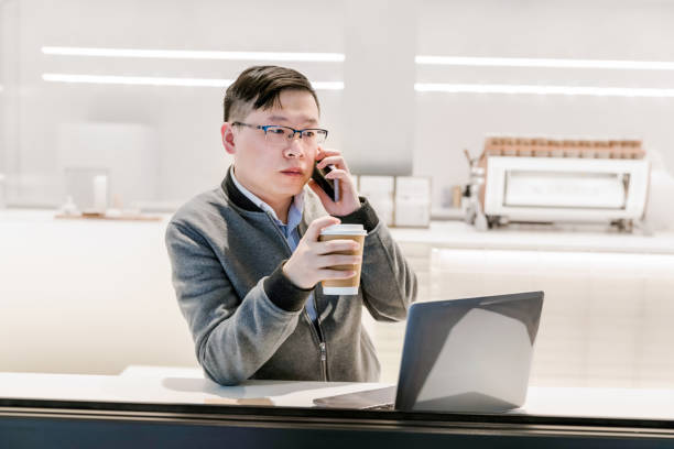 istock young man at coffee shop working on laptop 1310123391