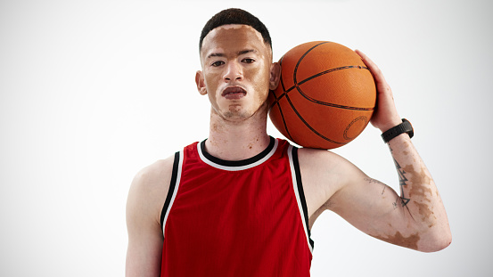 Cropped portrait of a handsome young male basketball player posing in studio