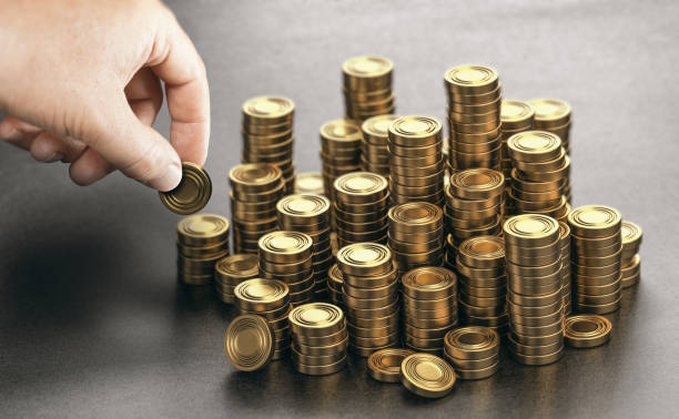 istock Rich man stacking golden money coins. Income saving plan. 1310123856