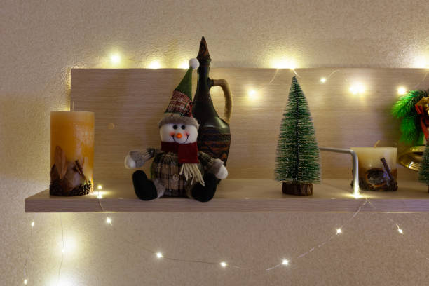 istock Christmas tree, snowman and candle on the shelf 1310124710