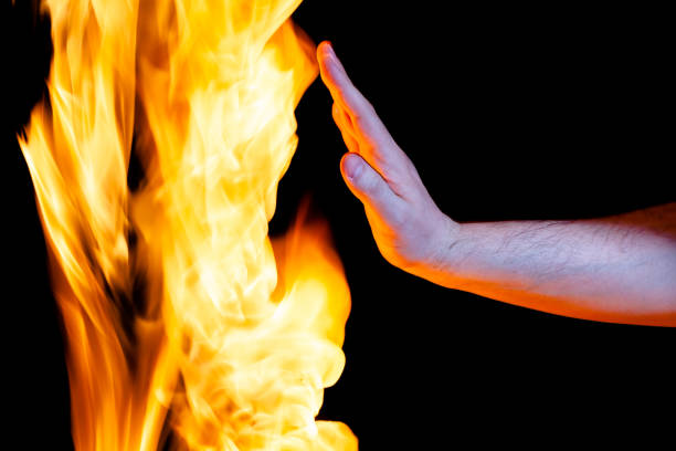 istock mens hand and flame, use as a background 1310124922
