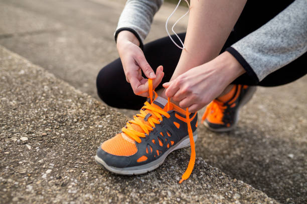 istock Young woman runner tying shoelace 1310125984