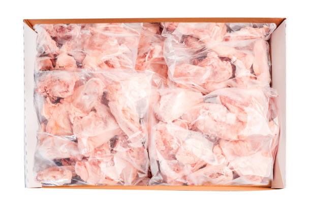 Raw meat box for supermarket, retail.Raw chicken backs in a package packed in a box for delivery on a white isolated background, top view.