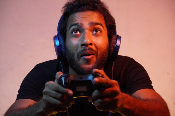 istock young man playing video game at home 1310127704