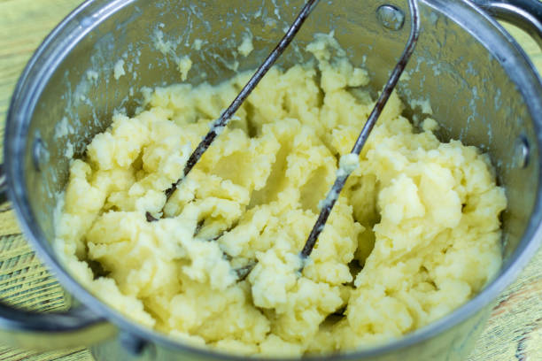 istock Cooking mashed potatoes in a saucepan. Crush boiled potatoes. 1310127759