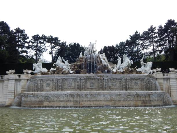 istock Magnificent Neptune fountain towards the white sky 1310127794