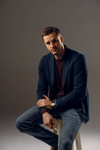 istock Handsome surgeon with needle holder and surgical knife weared casual suit in studio. Confident business man on dark background 1310129032
