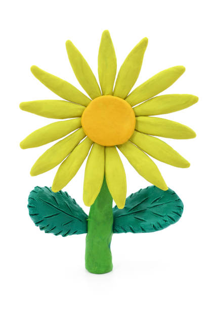 istock Plasticine yellow flower with leaves. 1310129389