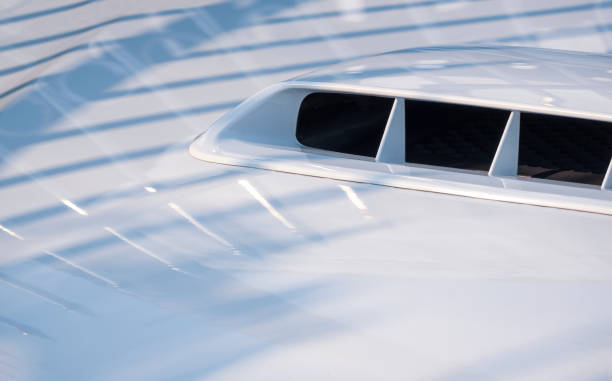 istock Close up image of hood air vent on white modern car bonnet with shadow reflection on surface 1310130111