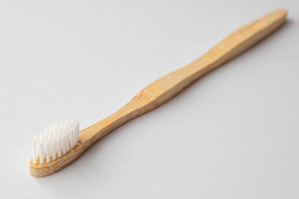 istock Wooden biodegradable toothbrush on white background 1310130260