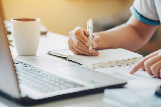 istock businessman working on project for analyzing company financial report balance statement with documents graphics at modern office space. Concept picture of business,economy, market,money and tax. 1310130579
