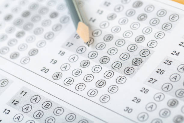 istock testing in exercise and exam paper. computer sheet with pencil in school test room, education concept 1310131722