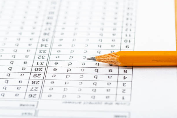 istock testing in exercise and exam paper. computer sheet with pencil in school test room, education concept 1310131725