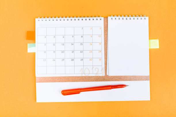 istock White blank 2021 calendar on solid orange background with copy space, business meeting schedule, travel planning or project milestone and reminder concept. 1310131892