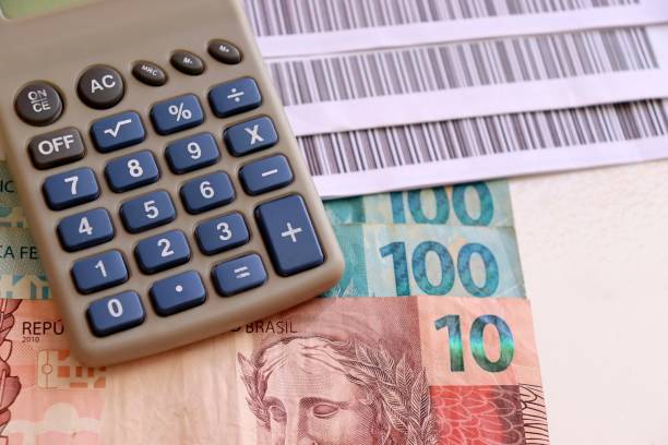 istock Brazilian money, calculator and bar code bills (boleto, fatura). 1310132149