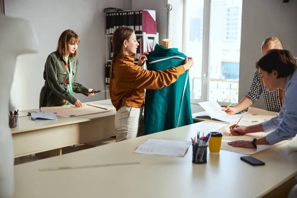 istock Tailor measuring the width of dress on dummy 1310133419