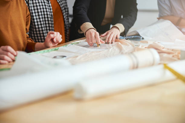 istock Talented dressmakers applying their pattern to the fabric 1310134228