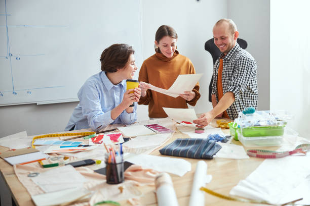 istock Amused coworkers comparing their drawings and smiling 1310134319