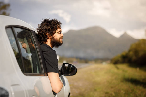 istock Man looking outside the car window 1310134796