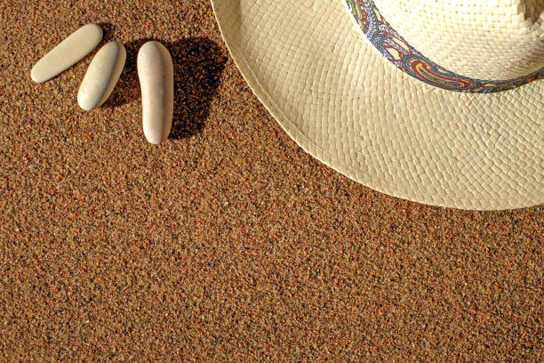 istock Straw hat and stones on sand, summer natural background with copy space 1310137227