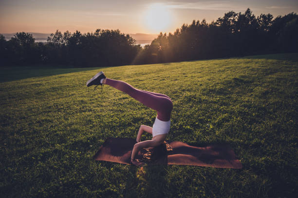 istock Young sporty woman practicing yoga, doing headstand exercise. 1310140622