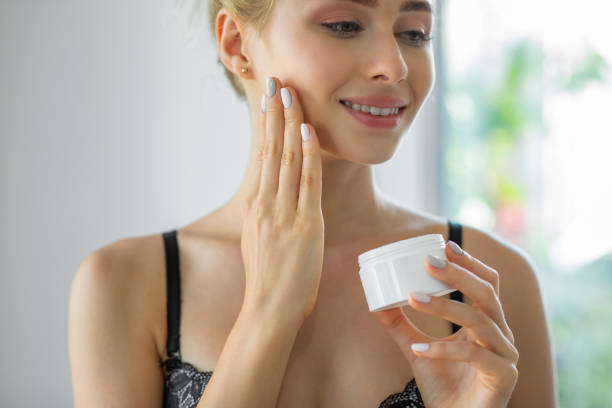istock Young woman putting face cream on her face 1310141612