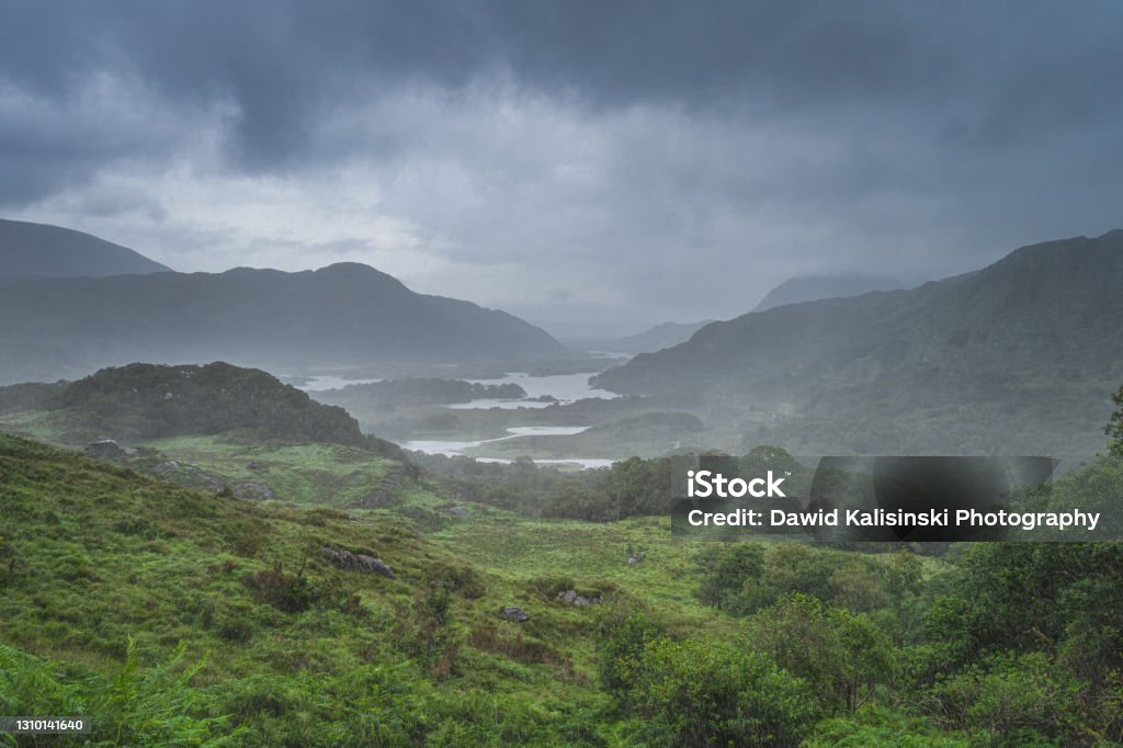 Dramatic storm sky, mist and heavy rain in Ladies View Atmospheric, dramatic storm sky and clouds, mist and heavy rain in Irish iconic viewpoint, Ladies View. Green valley with lake. Rink of Kerry, Ireland Ireland Stock Photo