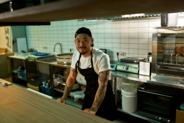istock Young chef standing at the table in the kitchen 1310144374