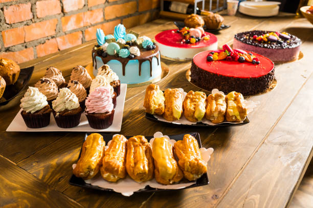 istock cakes on a sweet table and muffins with cream in candy bar 1310146101