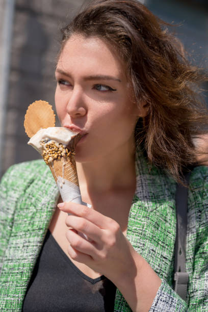 istock Woman eating ice cream in a cone 1310146128