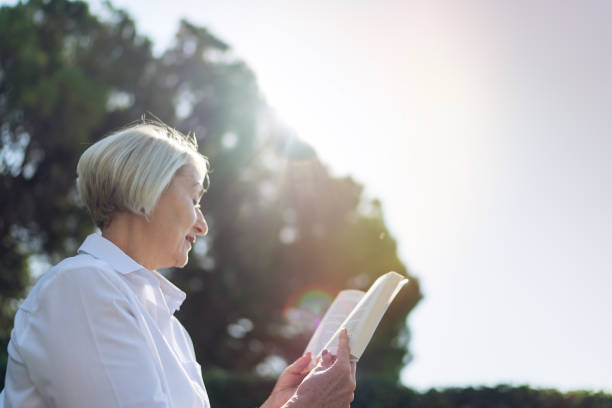 istock Woman reading a book while resting at the park 1310147179