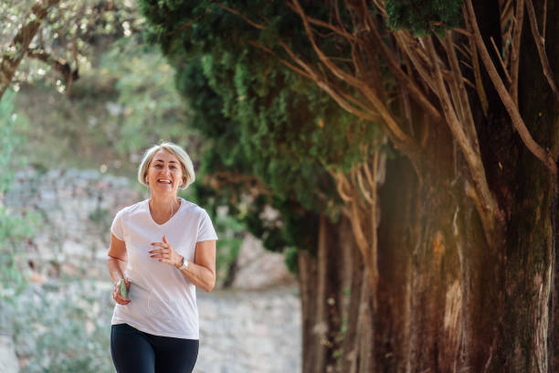 istock Senior woman jogging at sunrise 1310147325